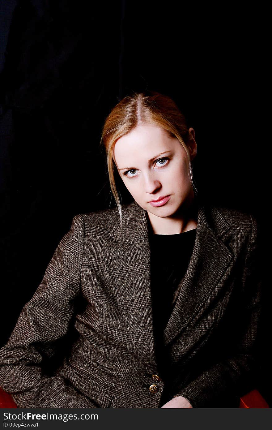 Portrait of the charming woman in a brown jacket. Portrait of the charming woman in a brown jacket