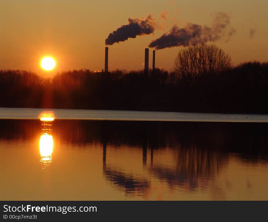 A power station in winter near a frozen lake. A power station in winter near a frozen lake.