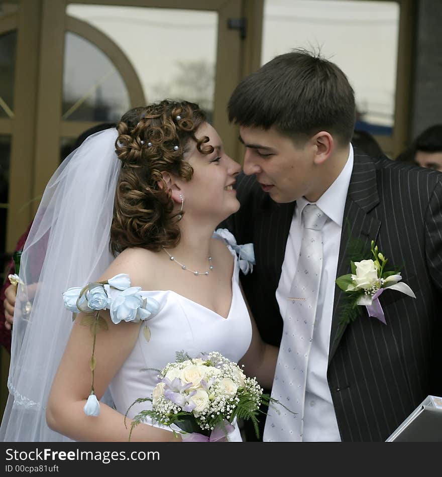 The groom kisses the bride