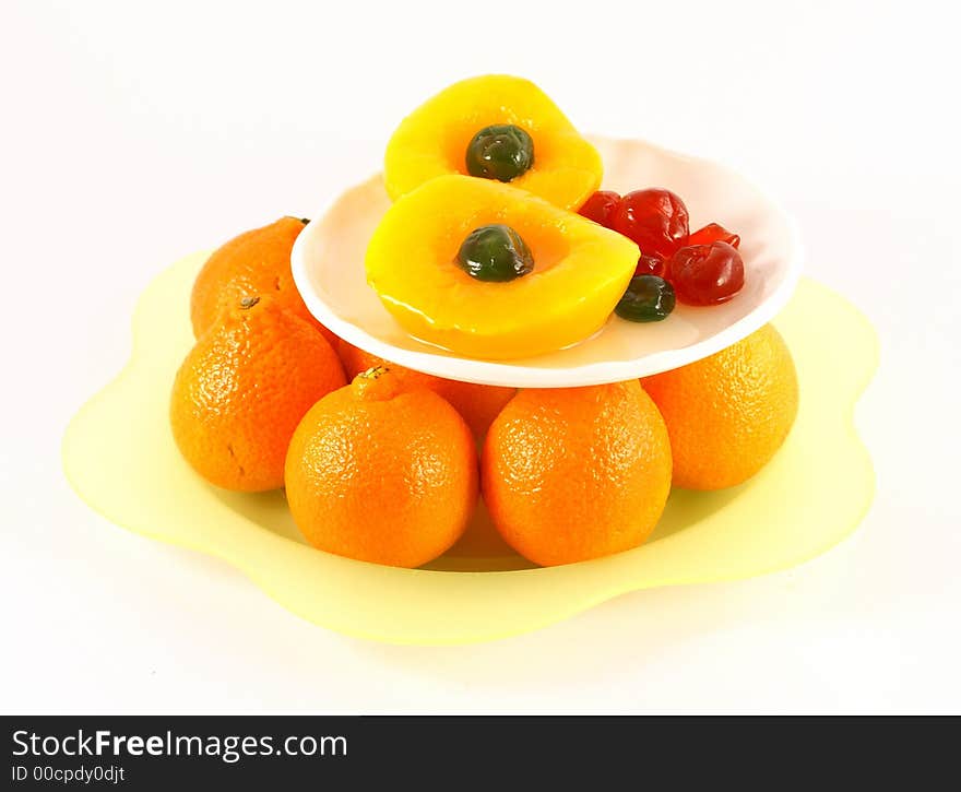 Isolated photo of fruits selections peach orange and glaced cherries