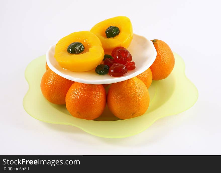 Isolated photo of fruits selections peach orange and glaced cherries