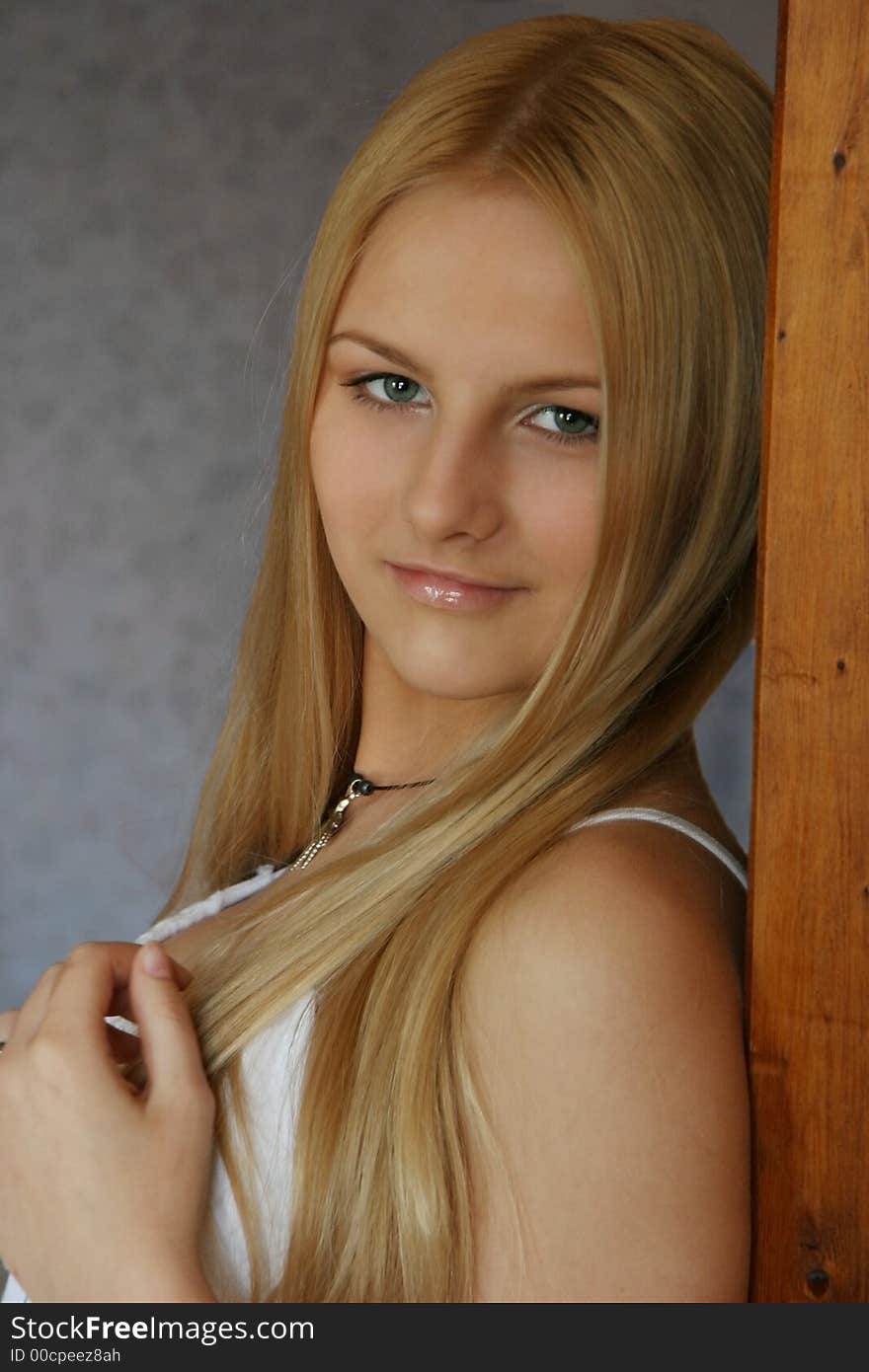 Portrait of a blond girl. Blue background. Portrait of a blond girl. Blue background.