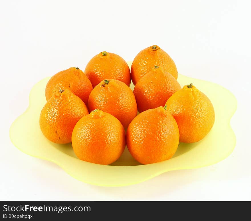 Isolated photo of of tangerine or orange on green plate. Isolated photo of of tangerine or orange on green plate