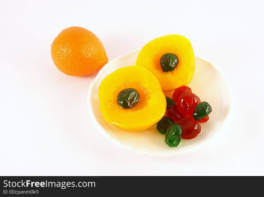 Isolated photo of fruits selections peach orange and glaced cherries