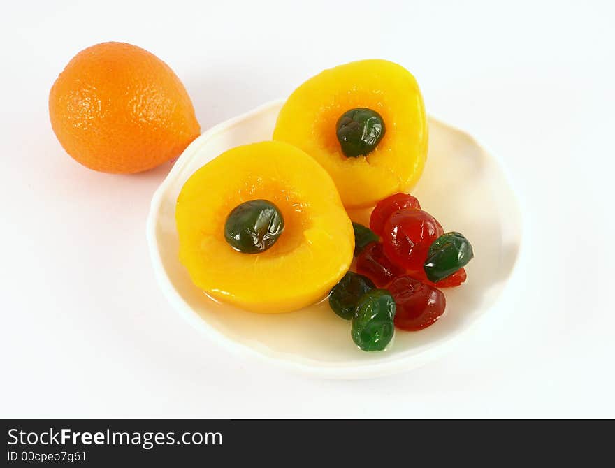 Isolated photo of fruits selections peach orange and glaced cherries