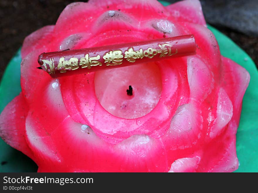 Pink candle at a temple during Chinese New Year celebrations in Qingdao, China.