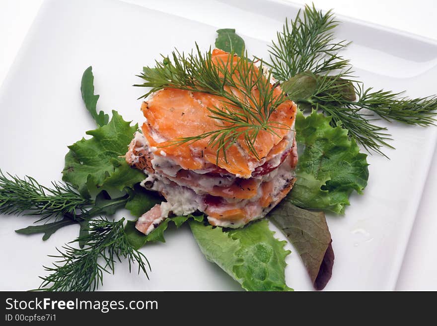 Smoked salmon with creamy cheese on a white plate