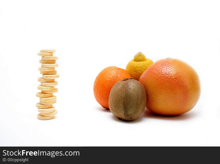 Fresh fruits versus pills, isolated on white surface