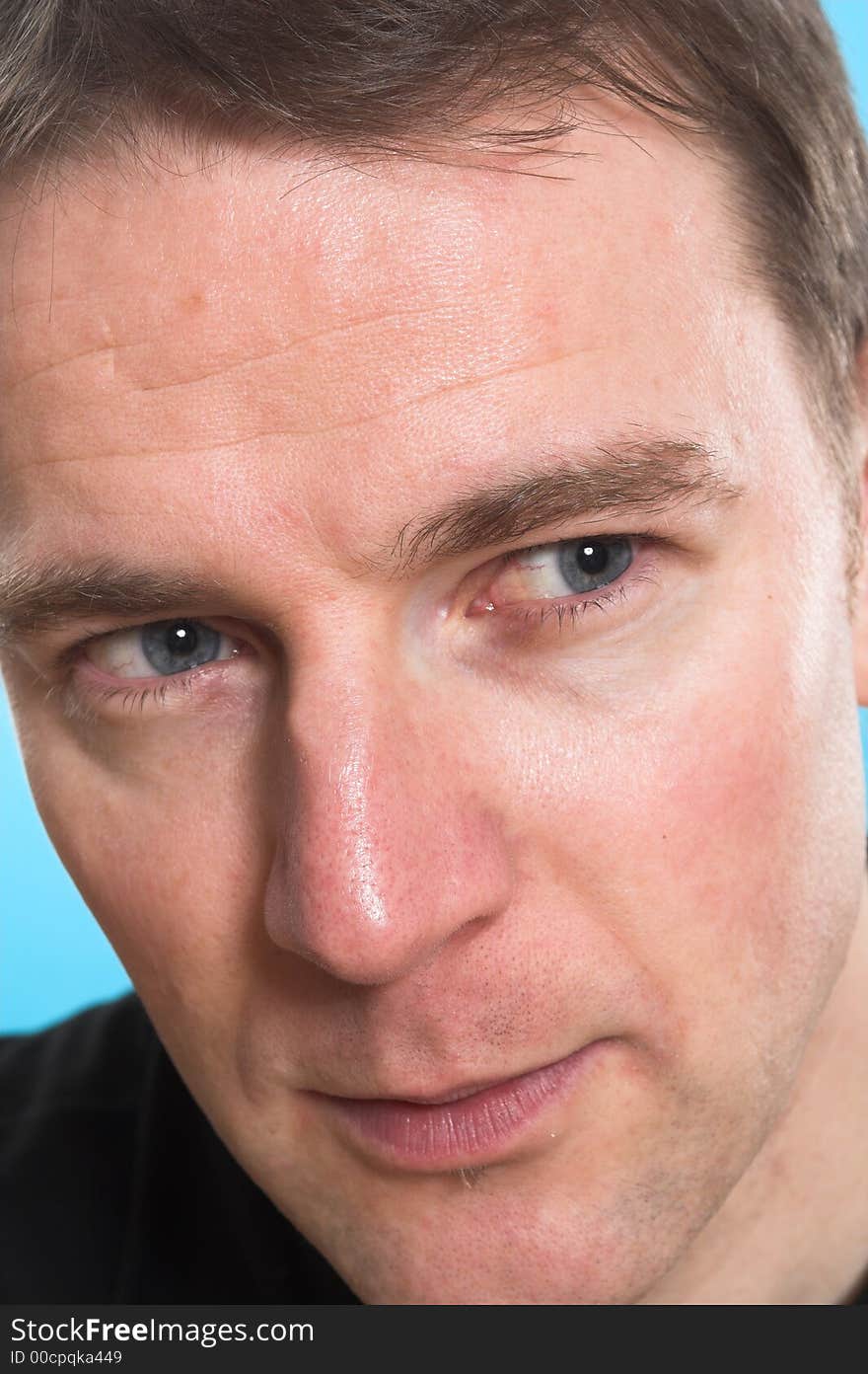 Face close up of a man over blue background. Face close up of a man over blue background