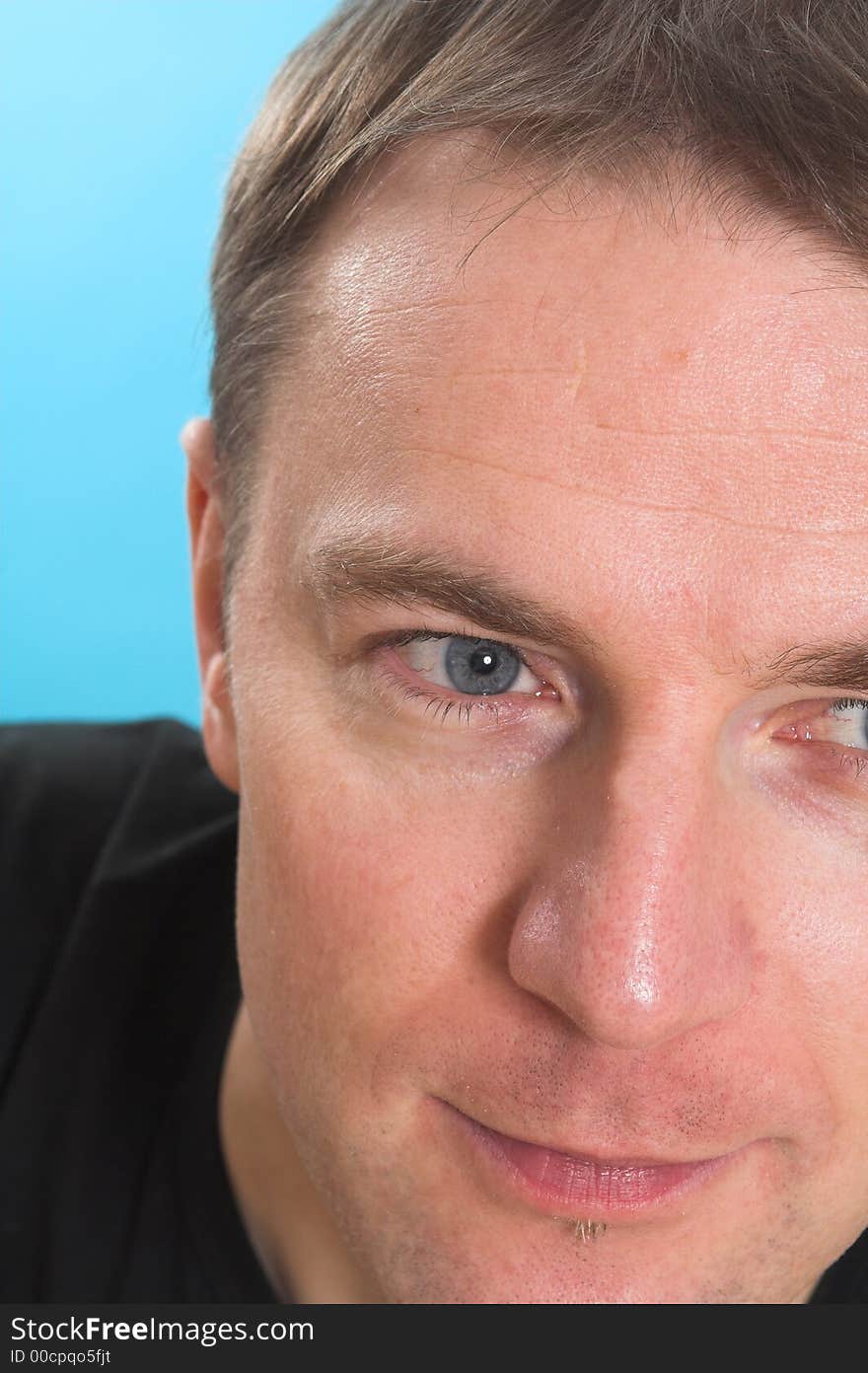 Face close up of a man over blue background. Face close up of a man over blue background