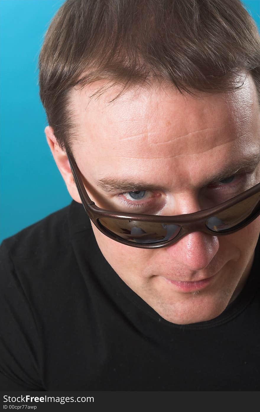 Face close up of a man over blue background. Face close up of a man over blue background