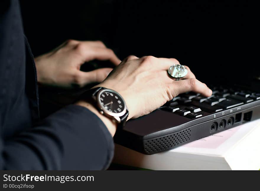 Hands writing on laptop with black background. Hands writing on laptop with black background