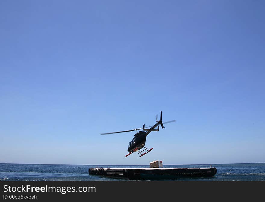 Helicopter take off over the Great Barrier Reef in Australia. Helicopter take off over the Great Barrier Reef in Australia