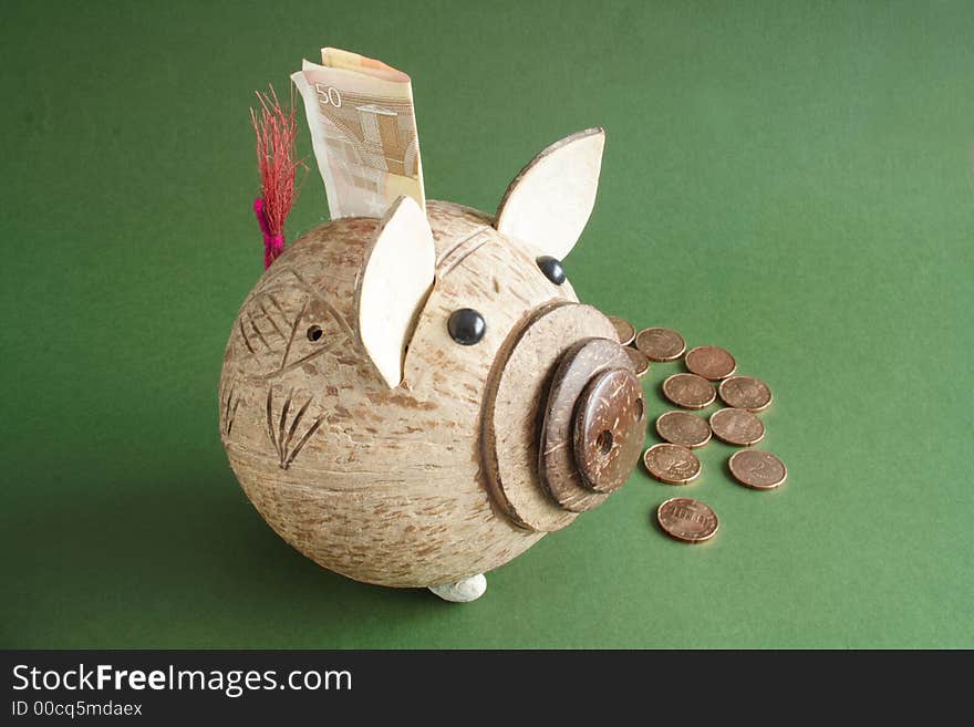 Saving pig and coins in a green background. Saving pig and coins in a green background