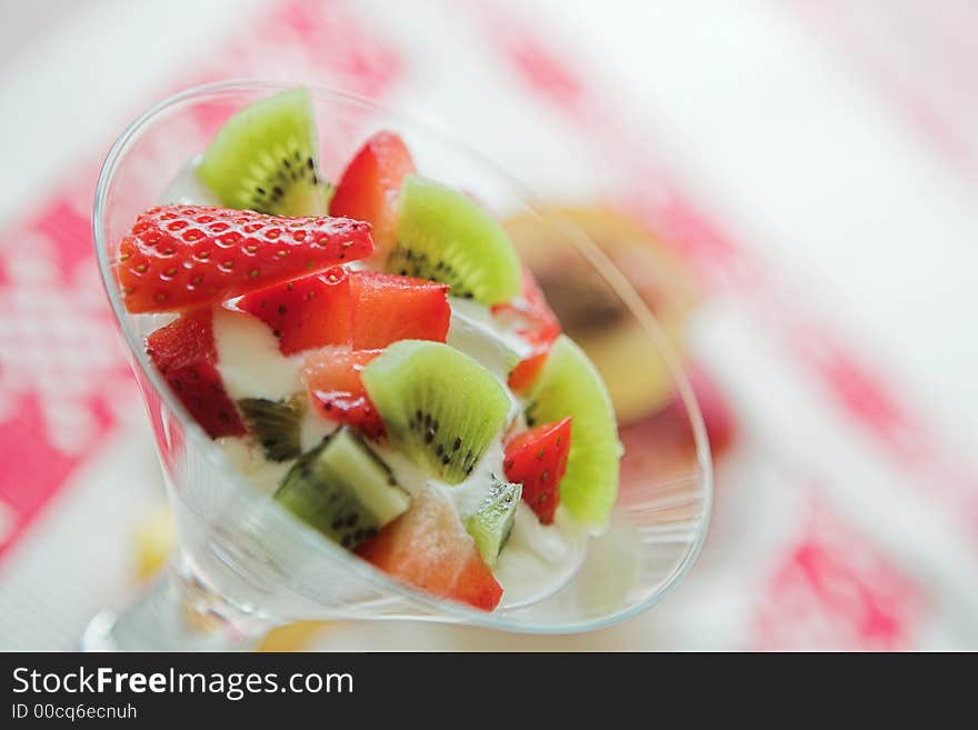 Kiwis, strawberries & creme fraiche - yummy - shallow depth of field. Kiwis, strawberries & creme fraiche - yummy - shallow depth of field