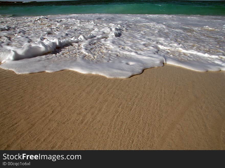 Retreating wave and wet sand. Retreating wave and wet sand