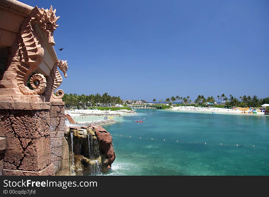 Vintage building and waterfall in a tropical lagoon and resort. Vintage building and waterfall in a tropical lagoon and resort