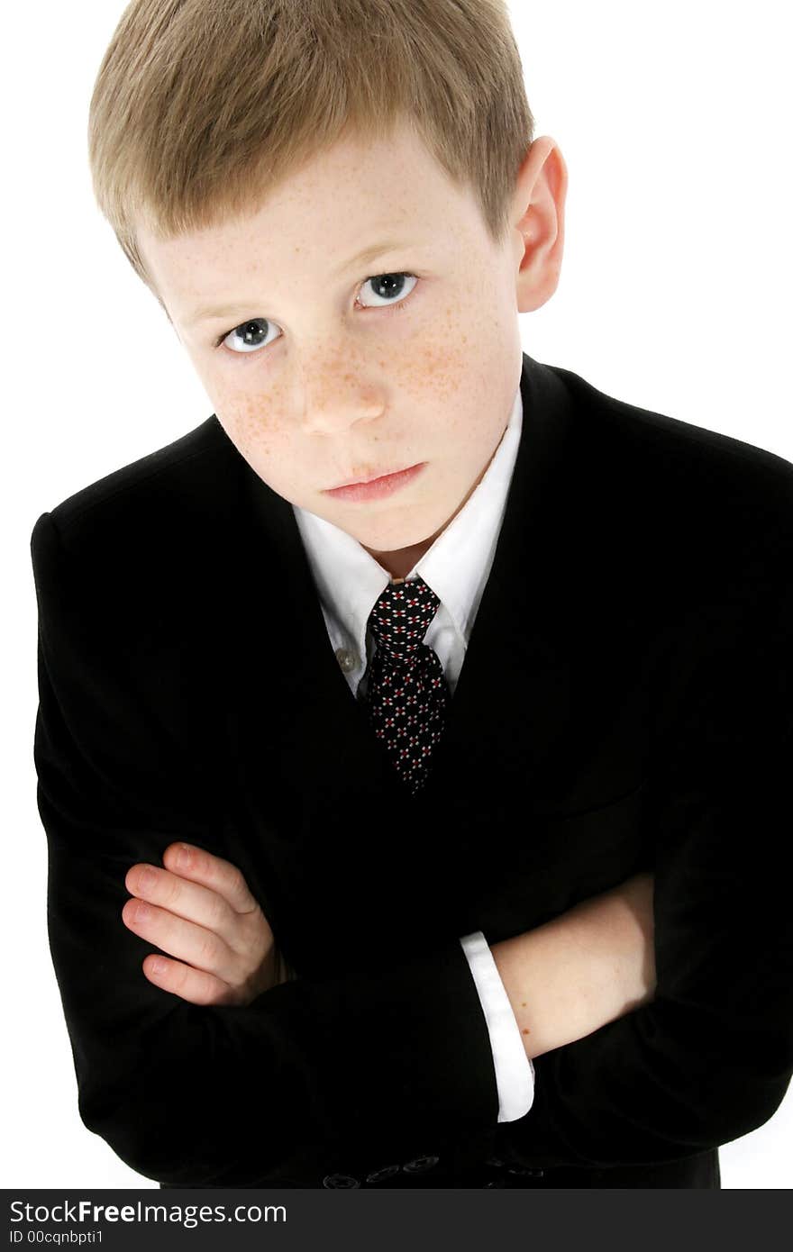 Little boy dressed in a suit; arms crossed with serious expression. Little boy dressed in a suit; arms crossed with serious expression