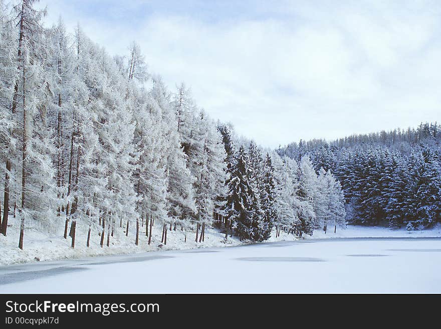 A lake in north Italy after a snowfall. A lake in north Italy after a snowfall