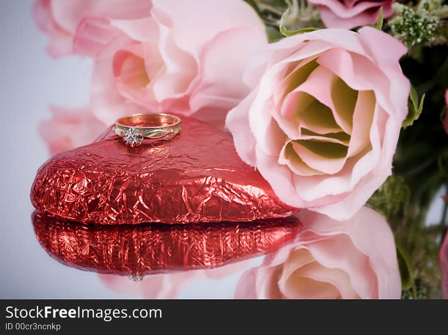 A gold engagement ring with heart and flowers