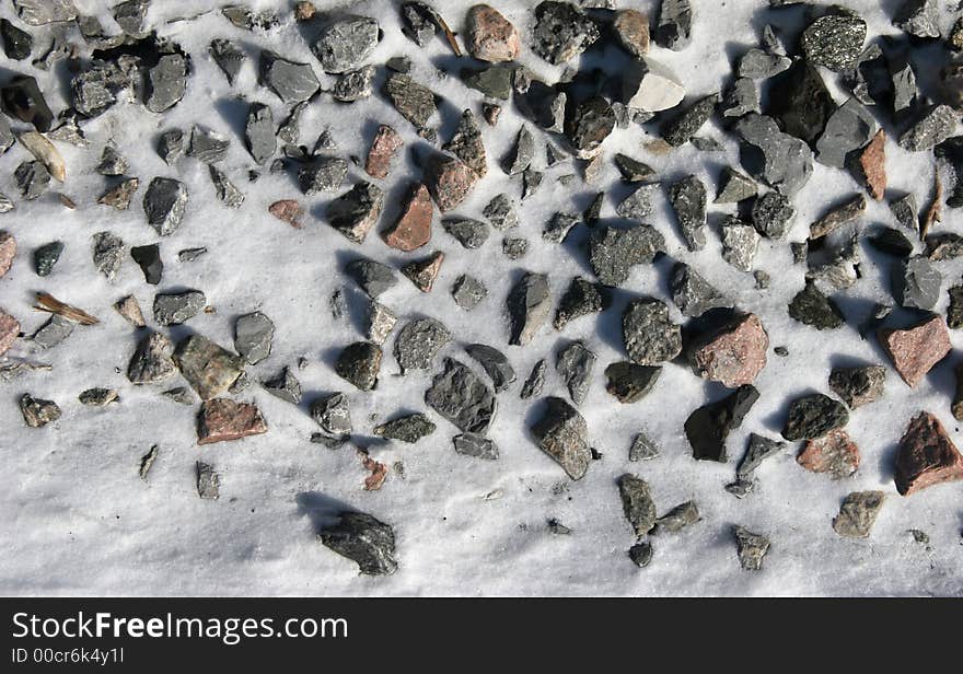 Stones in snow on a railway track