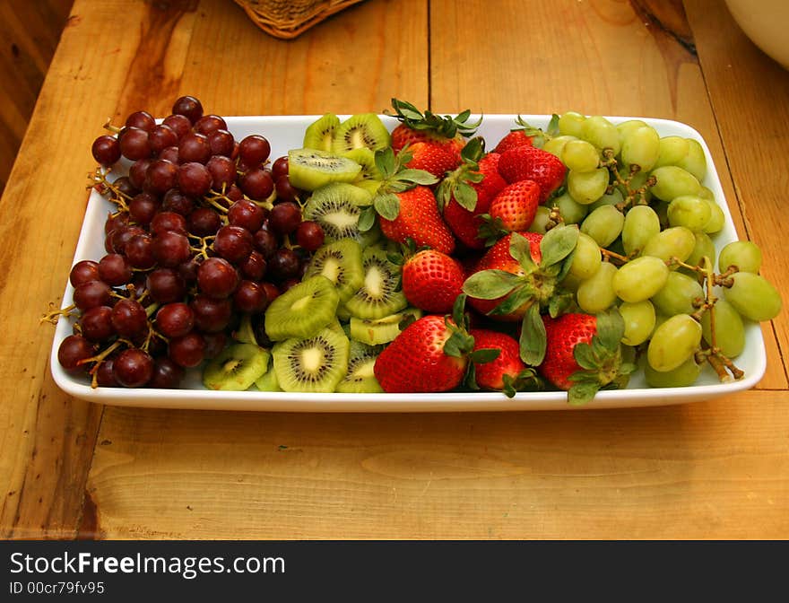 Grapes Kiwi and Strawberries on a Plate. Grapes Kiwi and Strawberries on a Plate