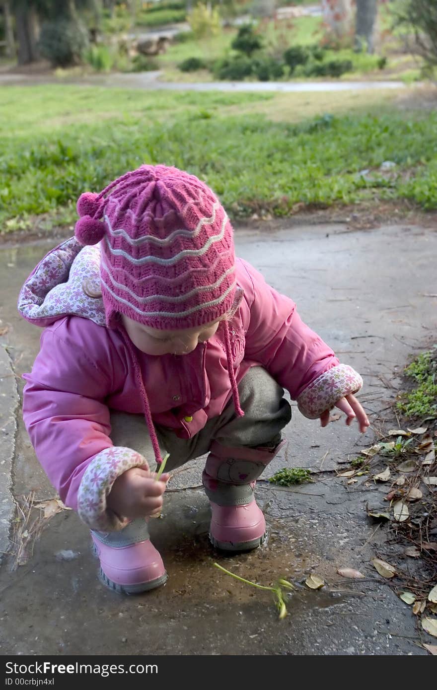 An 18 months old Israeli toddler playing in a puddle after the rain. An 18 months old Israeli toddler playing in a puddle after the rain.