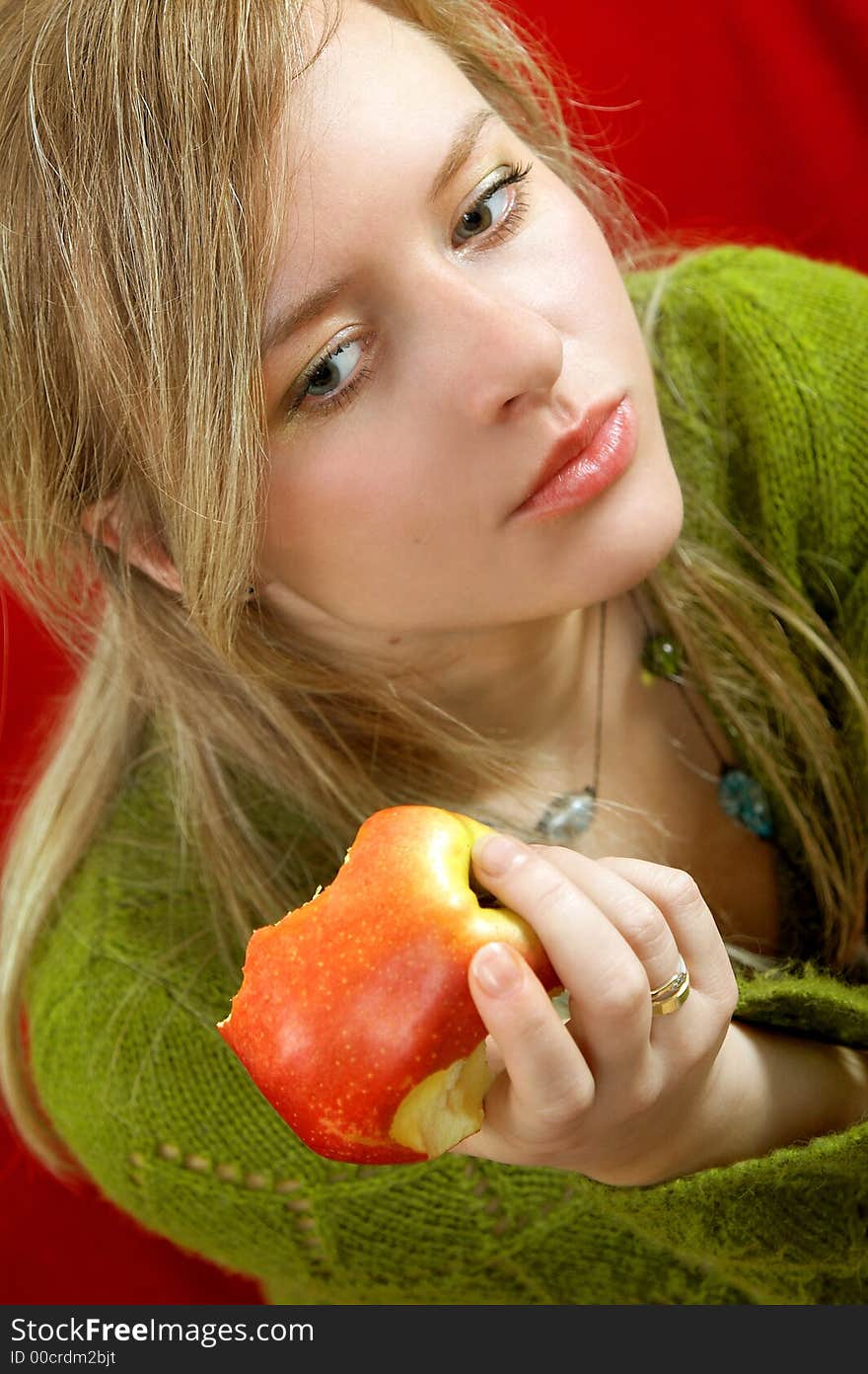 Pretty girl is holding a juicy apple in palm. Pretty girl is holding a juicy apple in palm