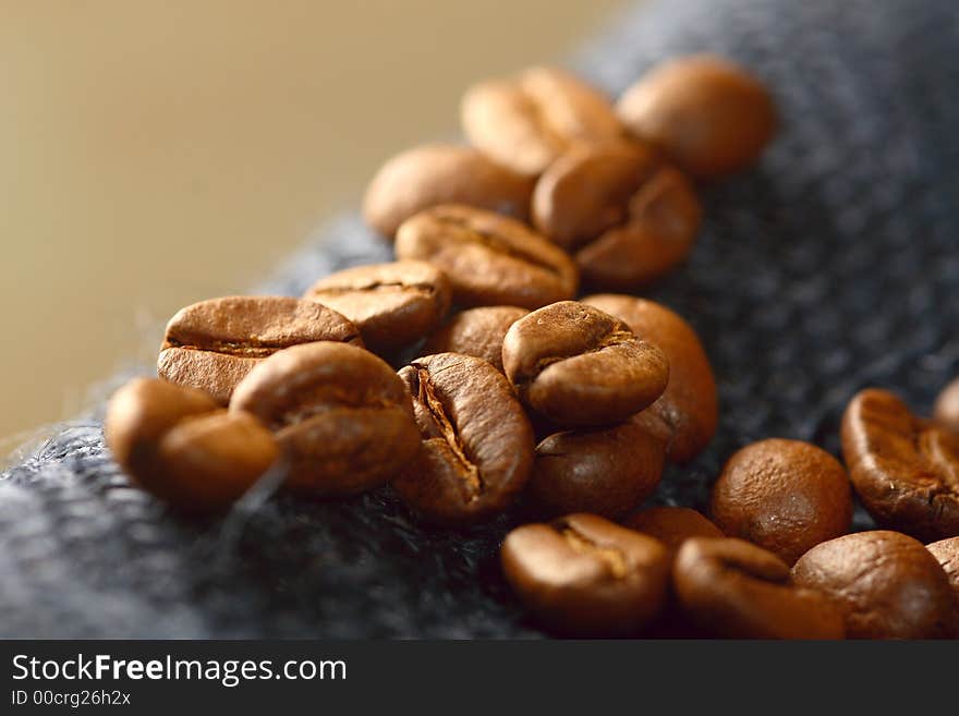 Coffee beans on blue jute