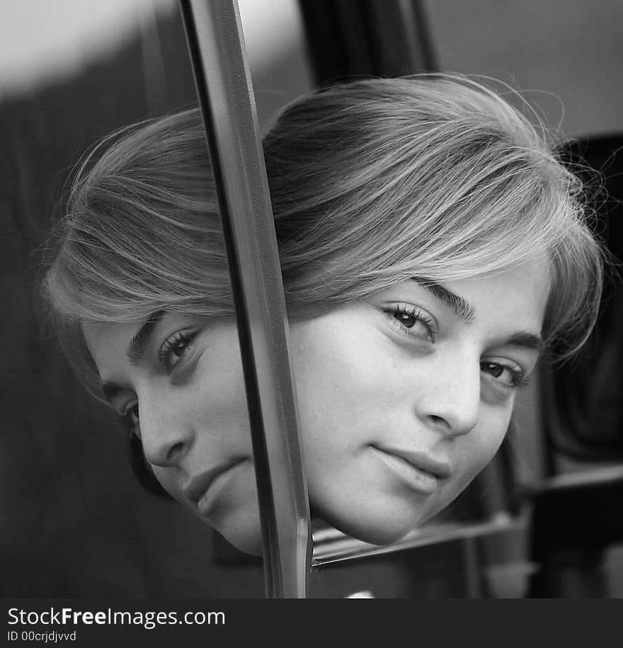 Blond girl reflecting on the car class. Blond girl reflecting on the car class