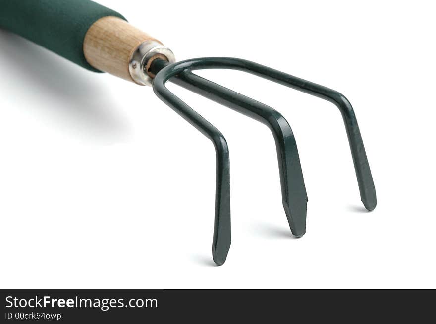 Green garden cultivator close-up on a white background.