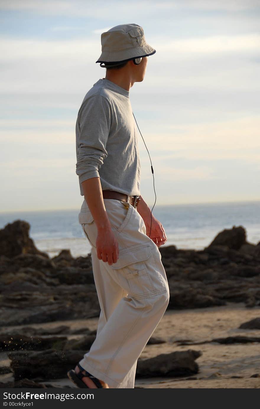 A single guy walking on the beach