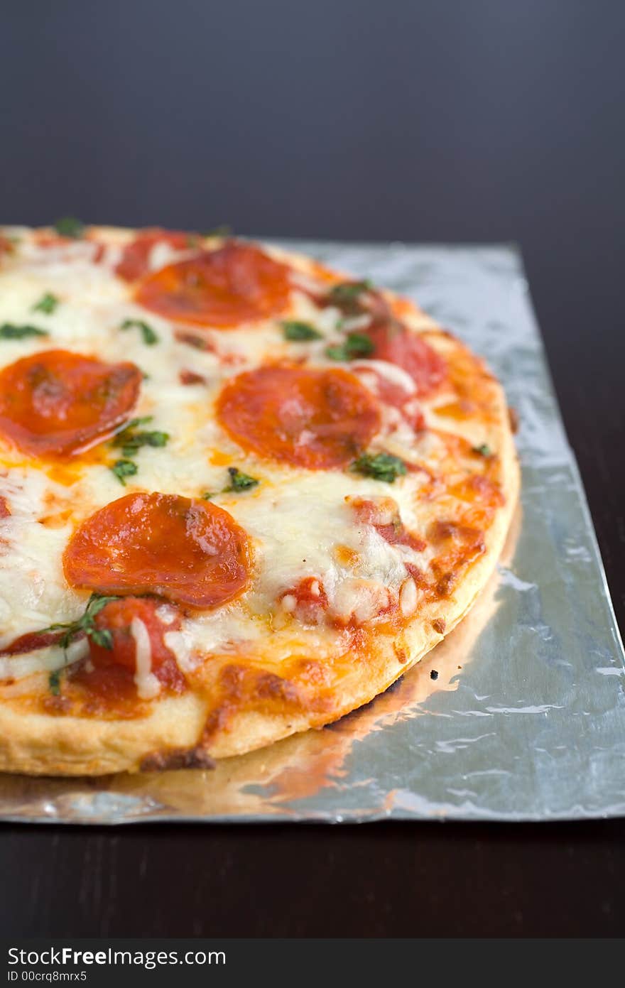 Pepperoni Pizza with mozzarella cheese and parsley fresh out of the oven