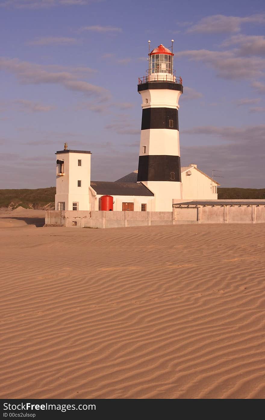 Lighthouse with nobody living in it on the coast. Lighthouse with nobody living in it on the coast