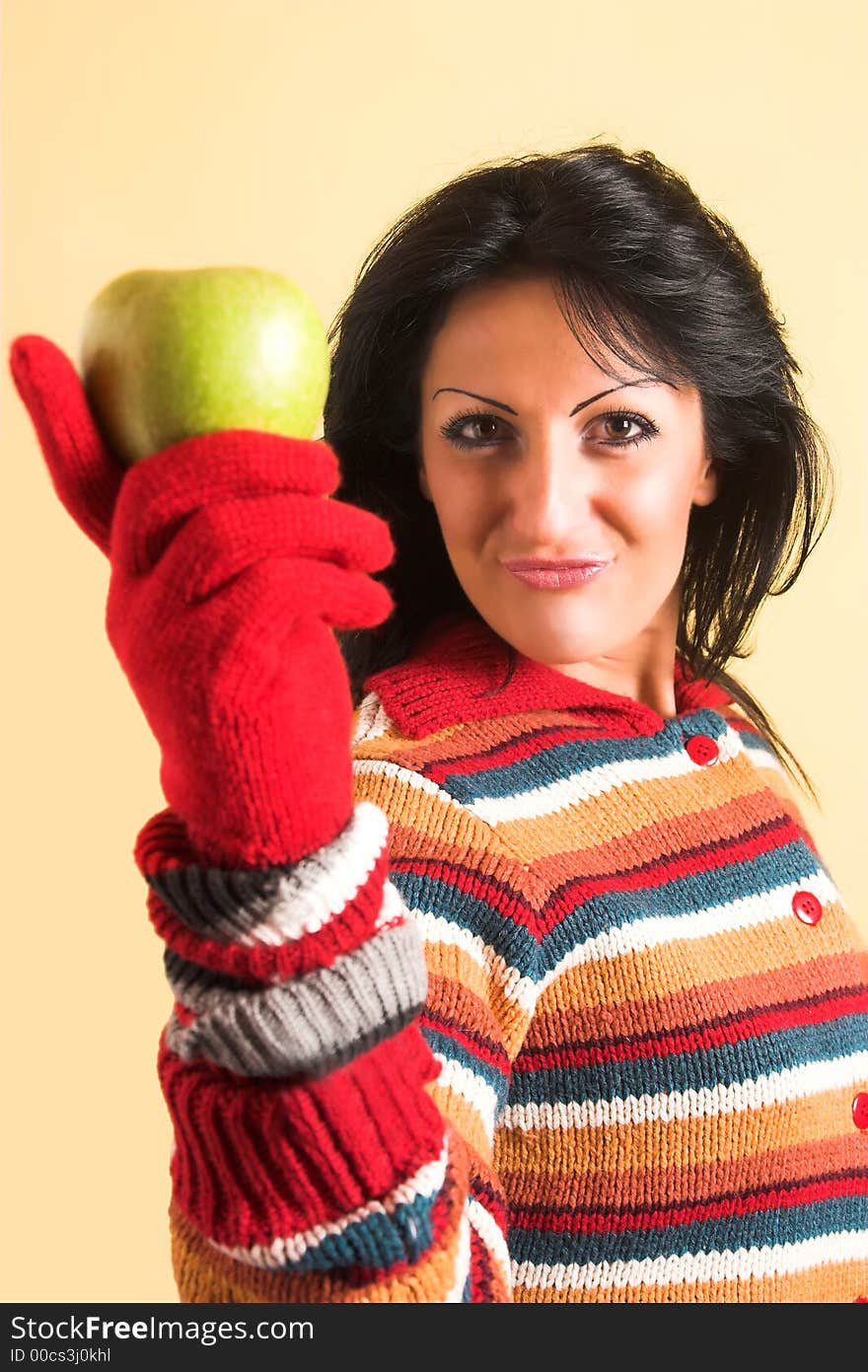 Young brunette woman with a green apple