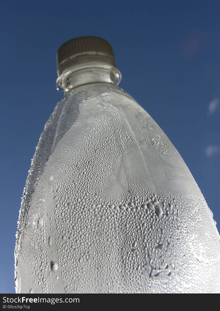 Water drops in a bottle and blue sky