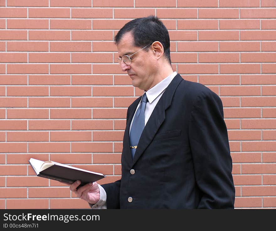 Outstanding businessman with briefcase and coat