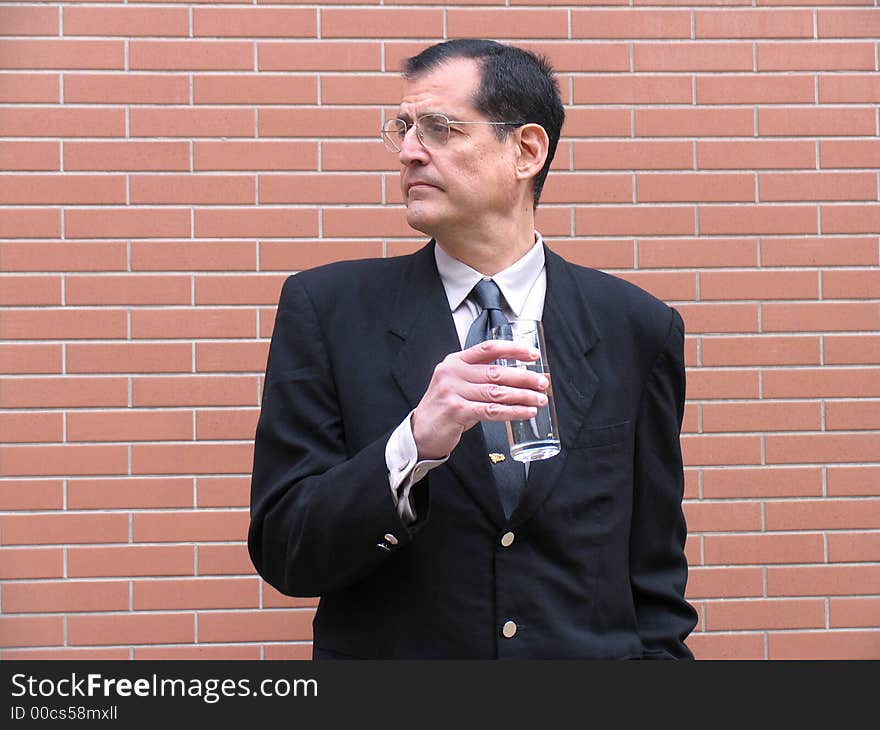 Outstanding businessman with briefcase and coat