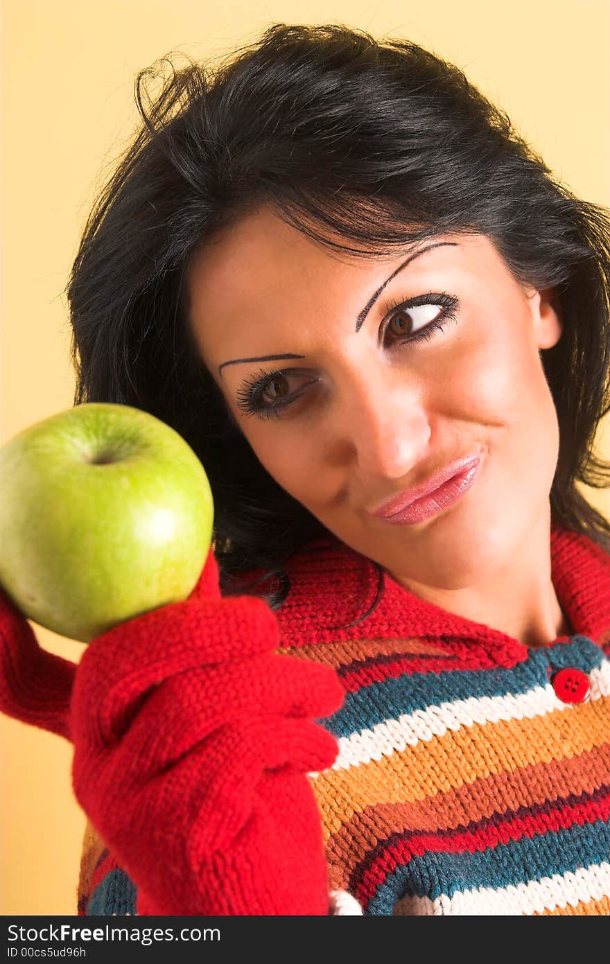 Young brunette woman with a green apple