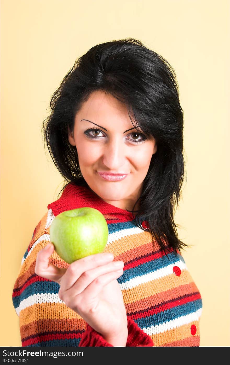 Young brunette woman with a green apple