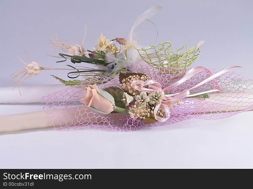 Pink flowers with on Easter candle