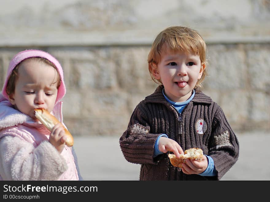 Two nice children outdoor eating. Two nice children outdoor eating