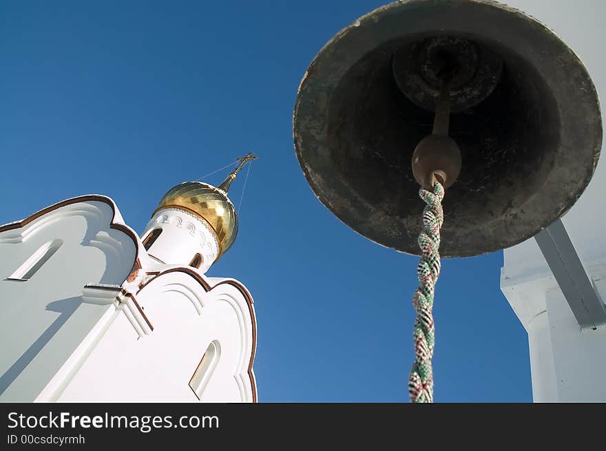 Bell and church on the sky background. Bell and church on the sky background