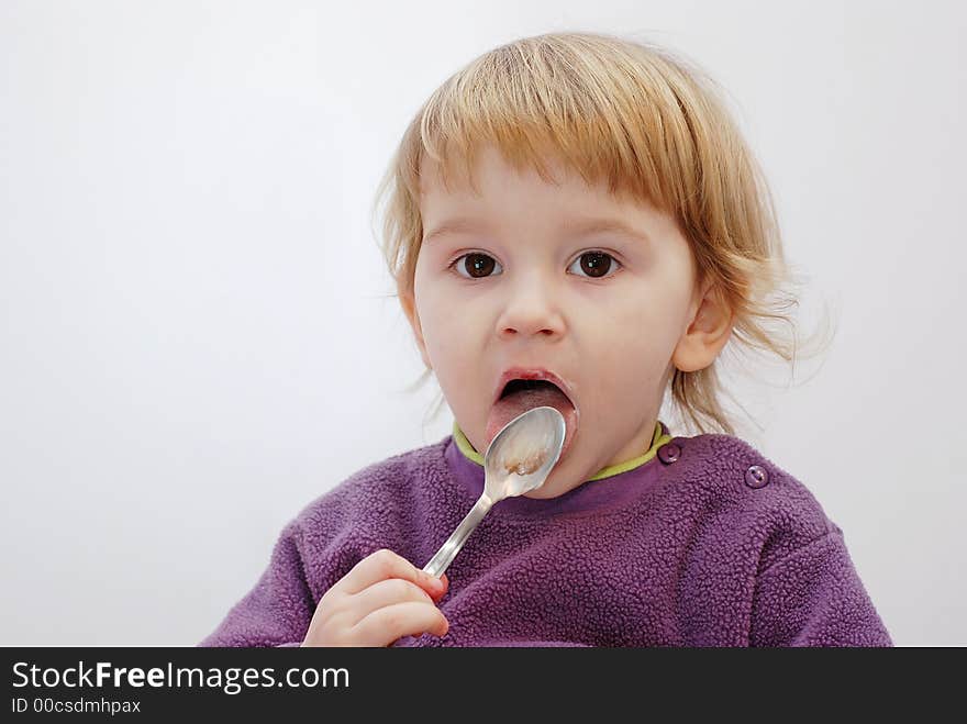 Child licking an empty spoon