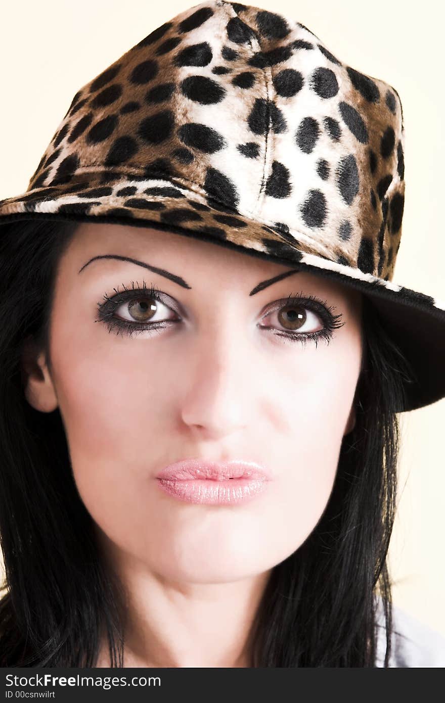 Beautiful brunette young woman with hat of leopard