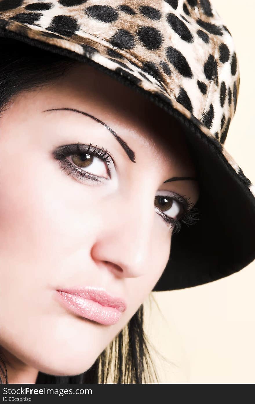 Beautiful brunette young woman with hat of leopard