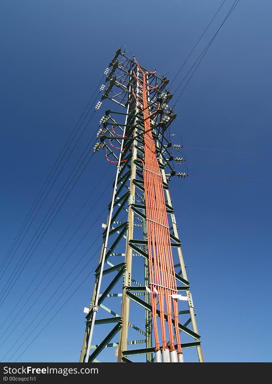 Solitary electricity pylon - against a blue sky