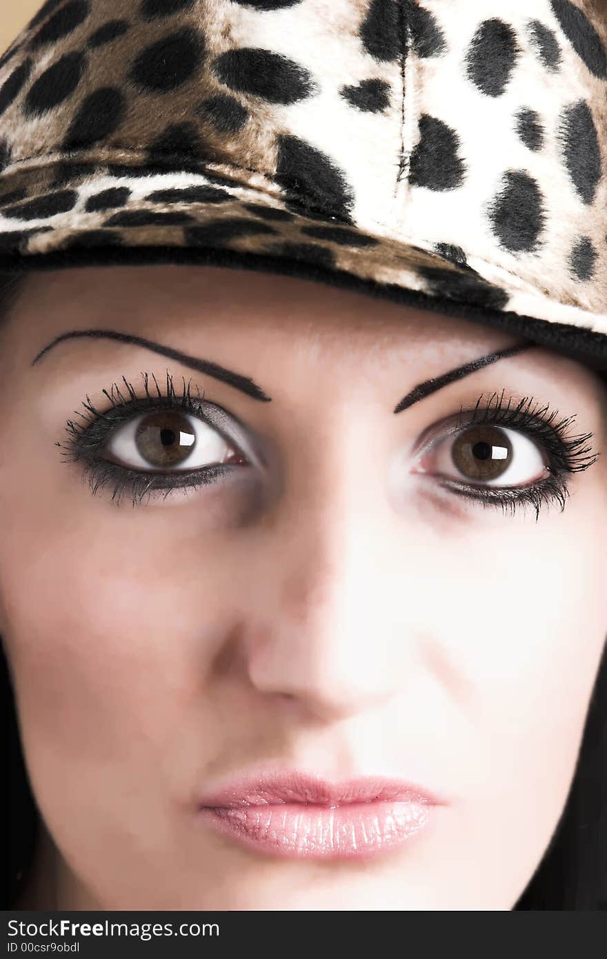 Beautiful brunette young woman with hat of leopard