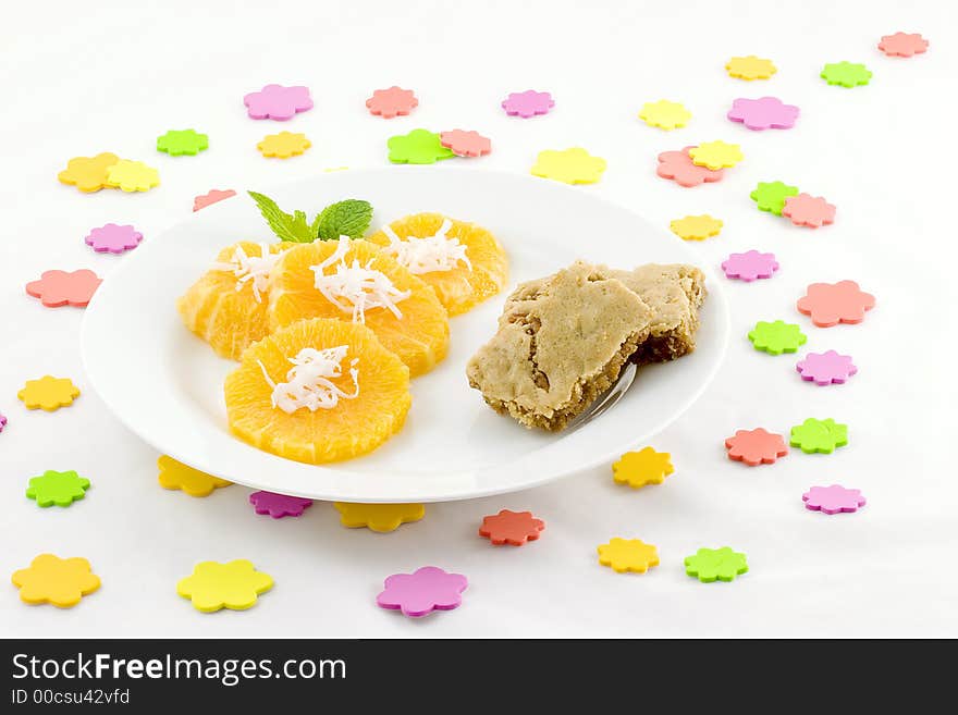 I scattered sponge dots over the table, then served orange slices topped with coconut and added  butterscotch brownies (Praline squares). I scattered sponge dots over the table, then served orange slices topped with coconut and added  butterscotch brownies (Praline squares).