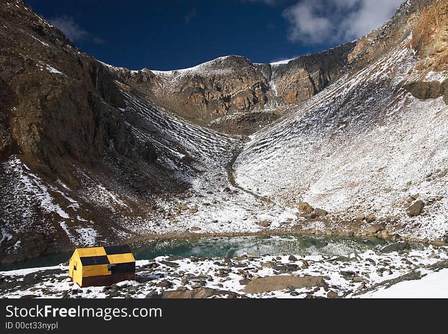 Mountains and yellow home.